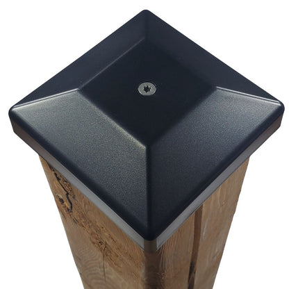 Black 4x4 post cap fastened to a wood fence post