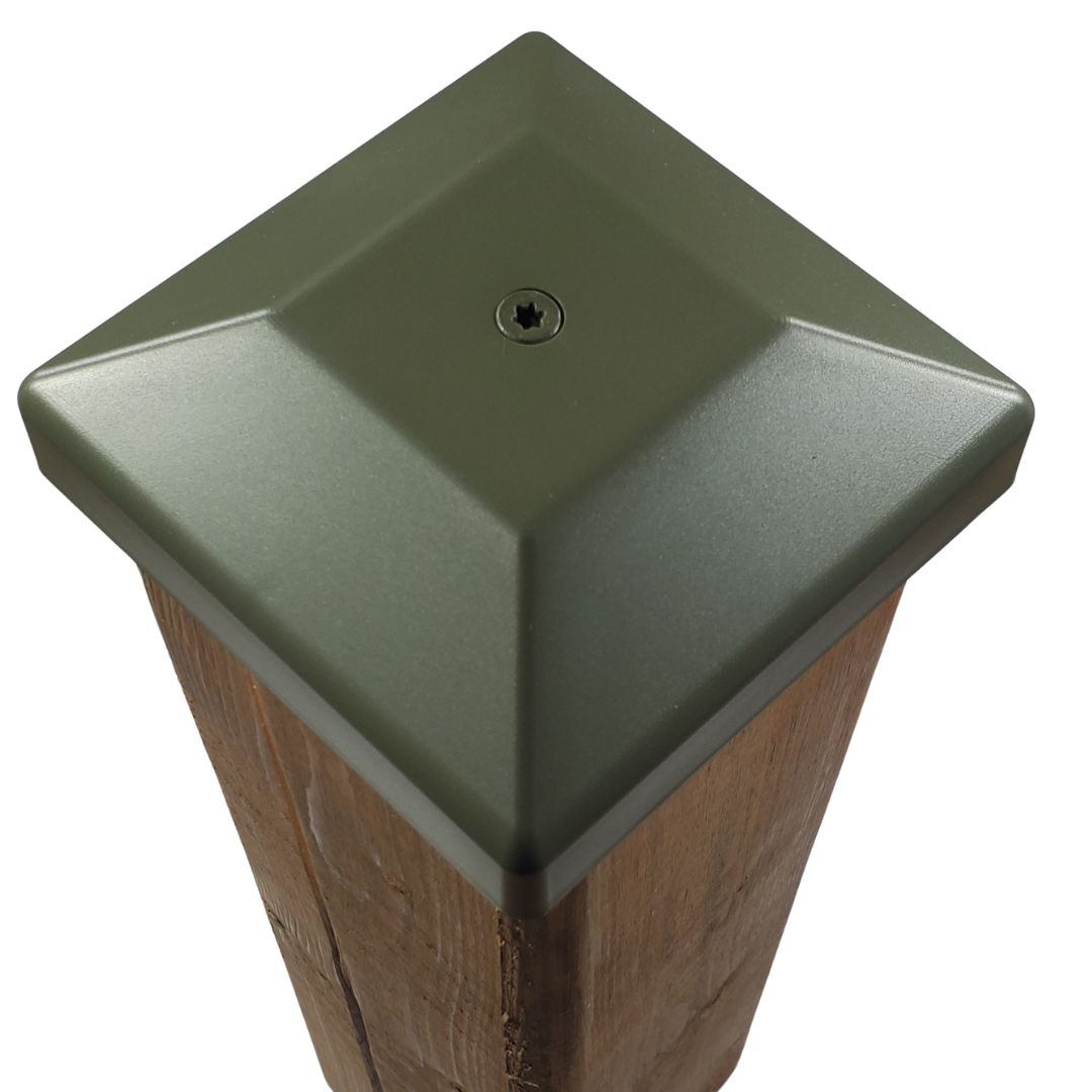 Green 4x4 post cap fastened to a wood fence post