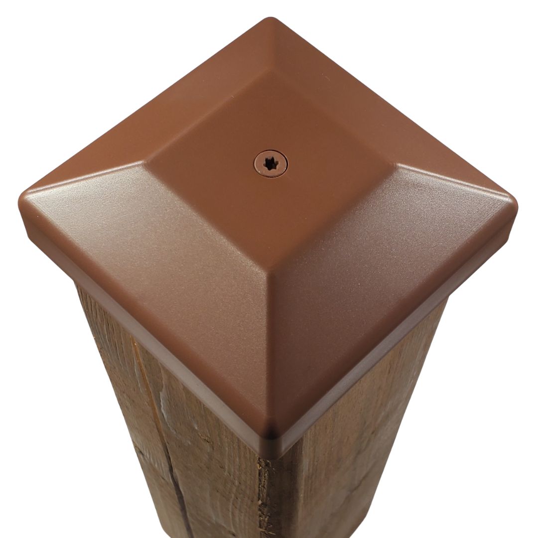 Red 4x4 post cap fastened to a wood fence post
